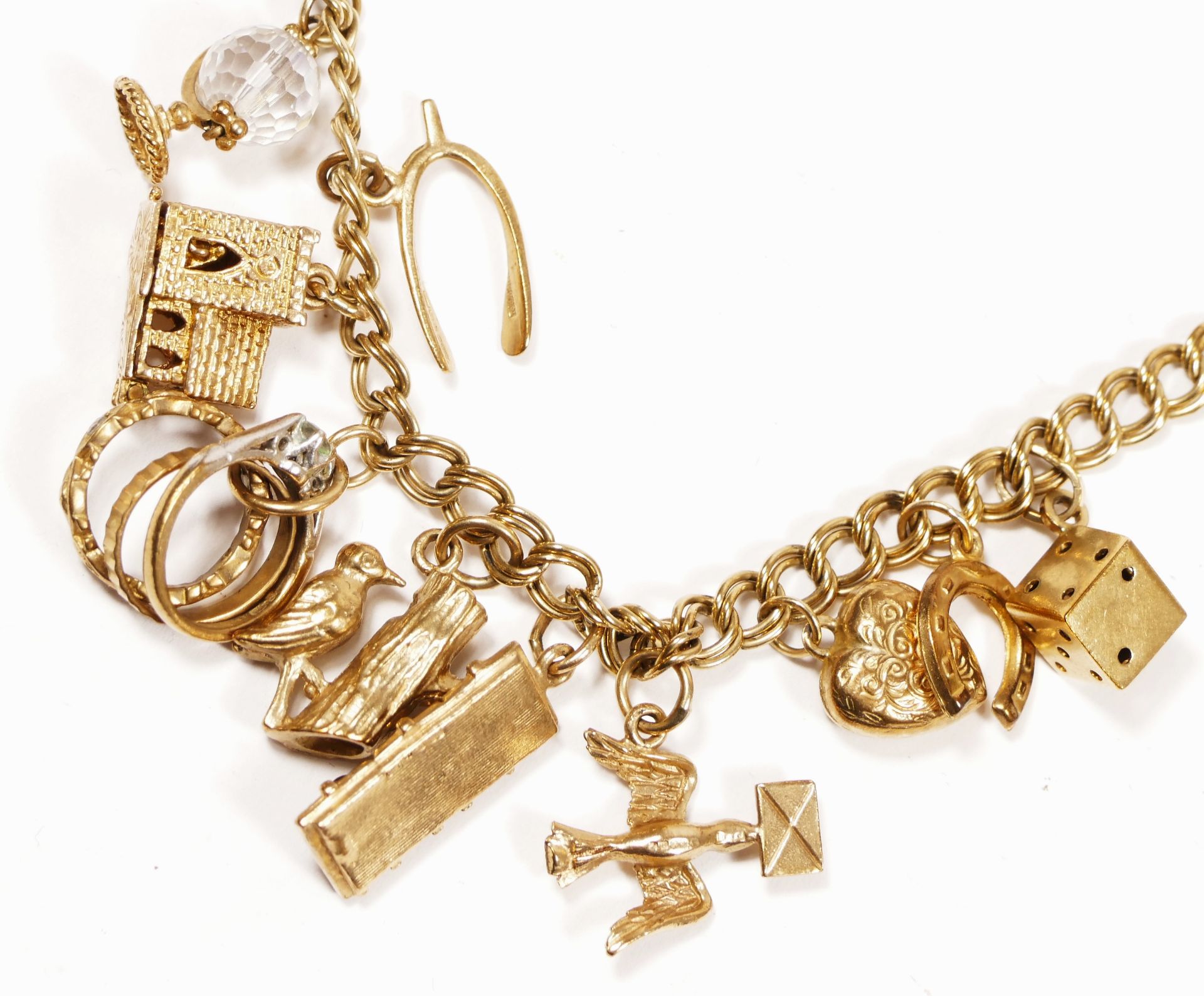 A 9ct gold curb link bracelet, with multiple charms, including a church and a traffic light, 32.4gm - Image 4 of 6