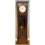 A 1950s Enfield longcase clock, oak case, having brass dial with arabic numerals housed with an