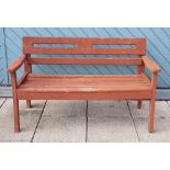 A hardwood garden seat. 128cm long.