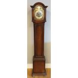 A 20th century oak cased grandmother clock, the brass and silvered face with pierced spandrels,