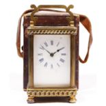 A Victorian brass carriage time piece, white enamel dial, curb link borders to the case, 13cm,