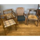 A pair of 1970s armchairs, together with a carved oak armchair and a rush seated example. (4)