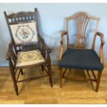 A mid 20th century oak open armchair, having shaped and incised top rail above a needlework backrest