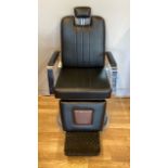 A 'Real Salons' made in England barber chair with headrest, having swivel action and hydraulic
