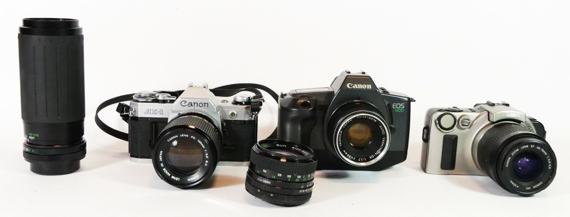 Three Canon cameras, to include a AE-1, a EOS600 and a EOs IX, with lens, together with two