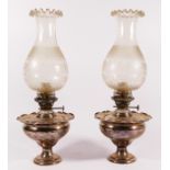 A pair of silver plated oil lamps with frosted glass shades (converted to electric) 39cm tall. (2)