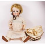 A German bisque head doll, impressed Germany 158-10, with sleeping blue eyes and two teeth,