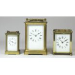 A square carriage clock, enamel dial with painted Roman numerals, movement unsigned, on bun feet,