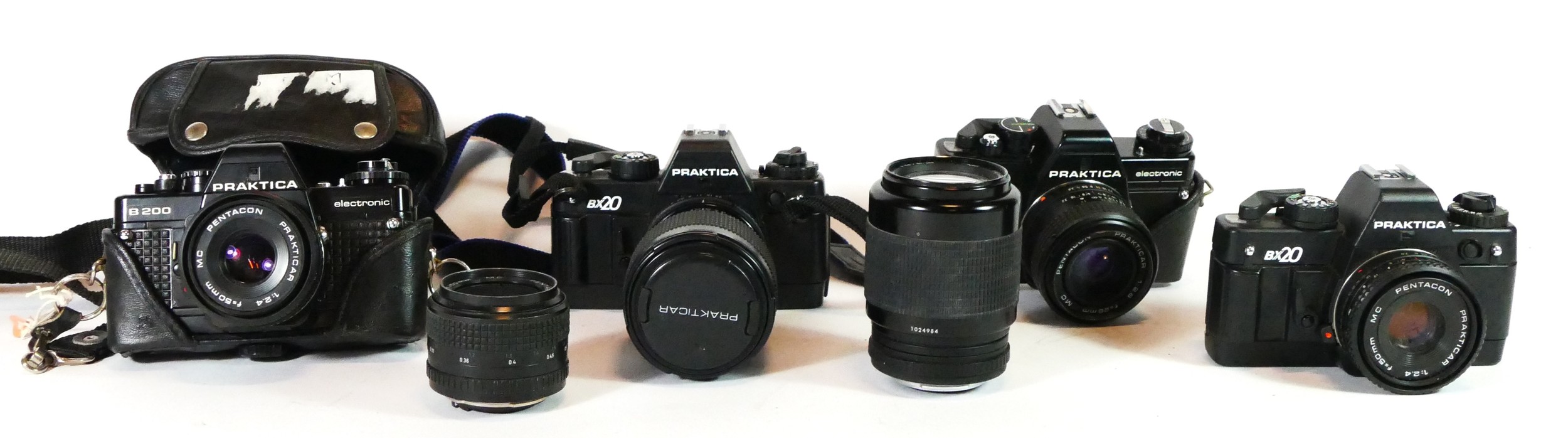 Four Praktica film cameras, to include a B200, a B100 and two BX20, with lens, also including two