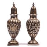 A Victorian silver pair of pepper pots, London 1897, loaded, 9cm