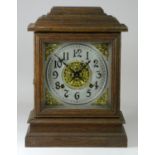 An eight day Ilion bracket clock by Ansonia, New York, dial with impressed Arabic numbers with
