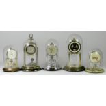 Five anniversary clocks, with glass domes, to include a Estyma, dial with floral decoration, a