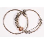 Pandora, a silver charm bracelet and another Pandora bracelet, 61gm