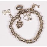 Links of London, a silver bracelet with five charms, 80.2gm, pouch and box.