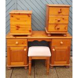 A modern pine dressing table with matching stool, together with a three height bedside chest of