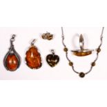 Three silver mounted amber pendants, a ring, a bracelet and a pair of ear studs, 56gm