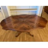 An Italian Sorrento dining table, the top having inlaid walnut and marquetry floral effect
