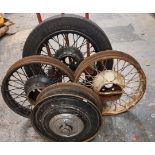 Three vintage wire wheels, one with a 3 1/2" x 19" tyre and another rim with a spinner