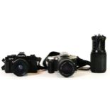 A Minolta X-7 film camera, with a 35mm-70mm lens, a Minolta Dynaxx 4, with a 100mm-300mm lens and
