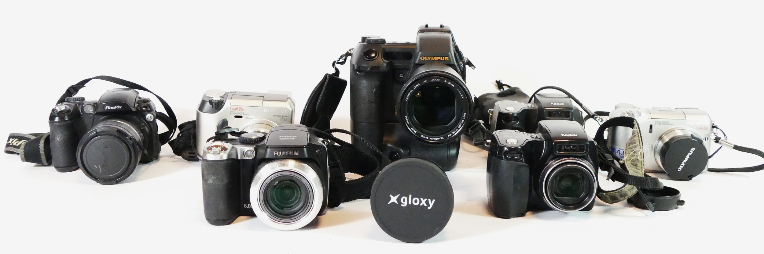 Seven bridge cameras, to include a Olympus E-Zop, a Kodak 27590, a Kodak DX6490, a Fujifilm 55000, a