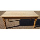 A rectangular pine country style kitchen table, raised on block and turned supports. L184, W90,