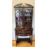 A Regency style mahogany display cabinet bookcase by T.Edmands of London, the scalloped shaped top