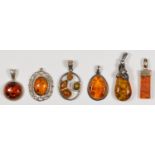 A collection of silver set amber jewellery, six pendants, 28gm