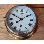 A ship's brass bulkhead clock by Sevill of Liverpool. England, with 8 day movement. 20cm diameter.
