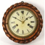 An oak cased wall clock, with rope style border, housing an 8 day movement. 24cm diameter.
