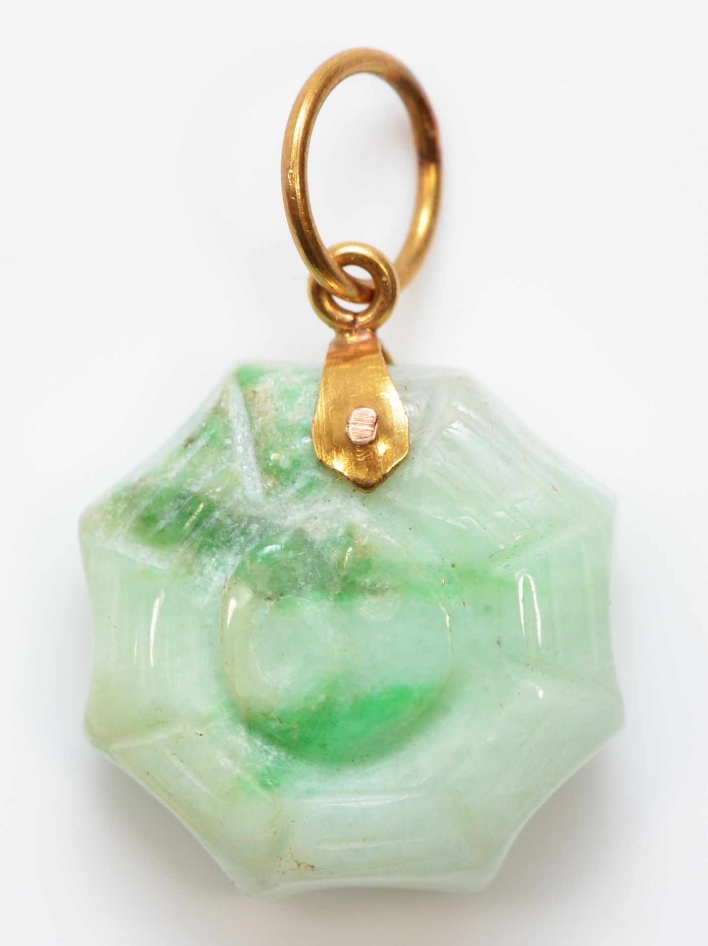 A gold mounted jadeite Yin/Yan pendant with spiders web border, 15 x 4mm