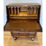 A 1950s Art Deco inspired oak bureau, the hinged writing slope opening to reveal inset leather