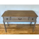 A modern Stag console/hall table, having central frieze drawer flanked by two short drawers with