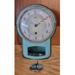 A 1950s Art Deco style Smiths Enfield wall clock, the painted cast aluminum case with silvered