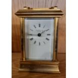 An English gilt brass 8 day carriage clock, having enamelled dial with Roman numerals, the