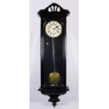 A late 19th century Vienna wall clock, having ebonised case with glazed door opening to a