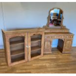 A Victorian stripped pine kneehole dressing table, having inverted breakfront with three drawers