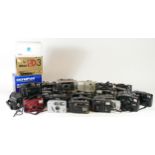 Thirty five compact film cameras, to include a Olympus trip AF, a Olympus Superzoom70, a Olympus