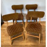 A set of four mid 20th century teak dining chairs, in the style of G-Plan 'Butterfly' design, with