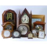 A collection of mechanical and quartz clocks, including wall clocks, mantle clocks, carriage clocks,