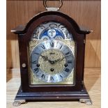 A German mahogany bracket clock by Hermle, with embossed gilt dial and slivered chapter ring with