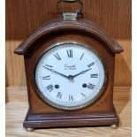 Comitti of London, a mahogany and inlaid mantel clock, having an 8 day movement striking on bell,