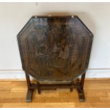 An Oriental carved tilt-top side table, the carved and glazed top depicting a Japanese street scene.