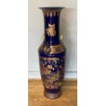 A Japanese floor standing baluster vase with flared rim, the shouldered body heavily decorated