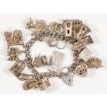 A silver charm bracelet, including a steam engine and hinged church, 103gm