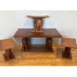 An Eastern hardwood occasional table of rectangular form, raised on carved wood models of elephants,