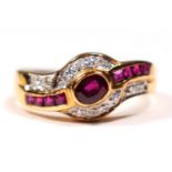 An 18ct gold (750) ruby and diamond ring, collet set with an oval mixed cut stone , flanked by