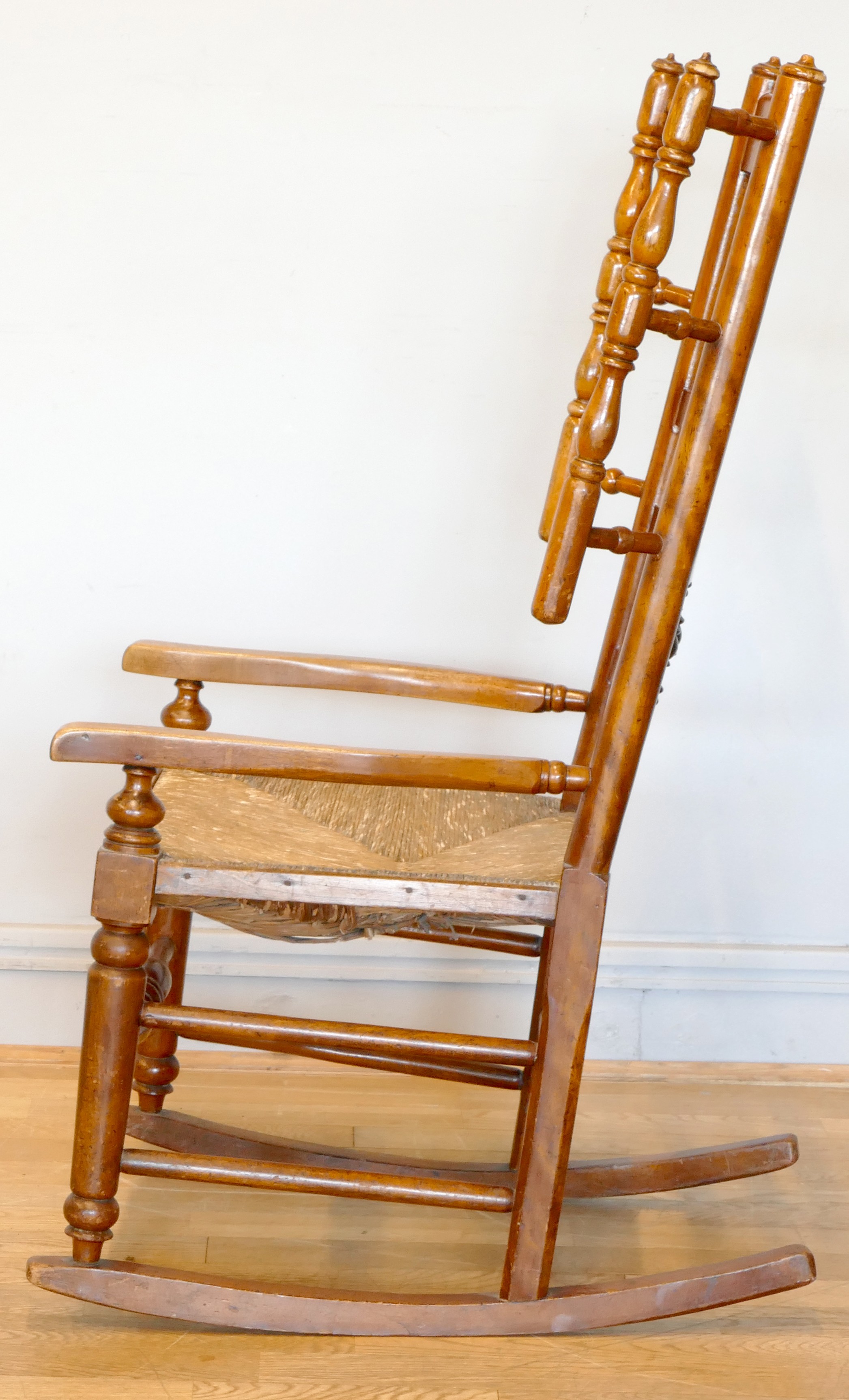 A 19th century Lancashire fruitwood winged rocking chair, having spindle back with rush seat, raised - Image 2 of 5