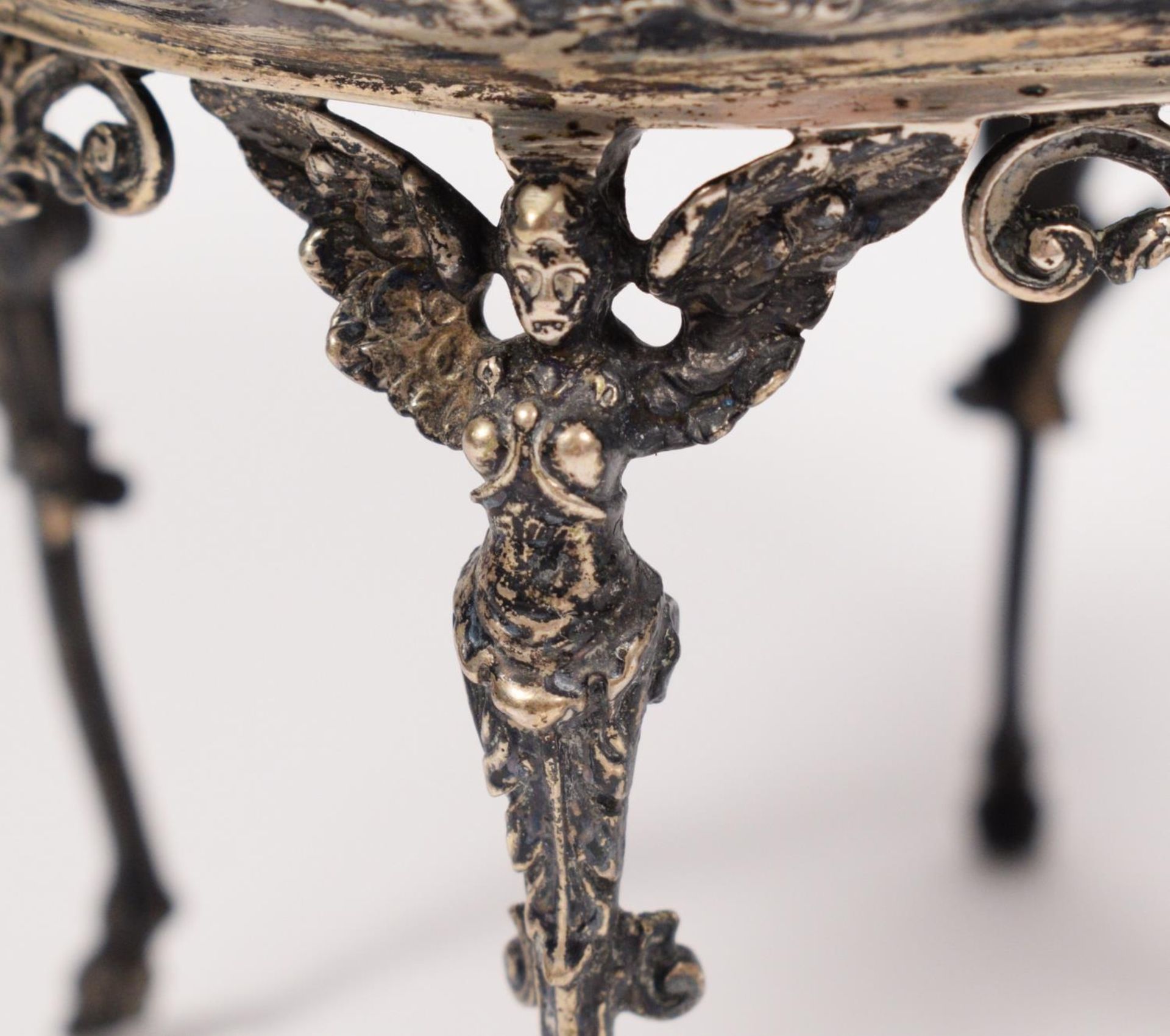 An early 20th century German bowl, with embossed decoration, raised on four winged angel legs, - Image 5 of 5