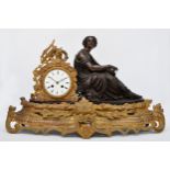 A 19th century French bronzed spelter and gilt metal mantel clock, the white enamel with Roman