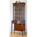 A Regency style mahogany display cabinet bookcase, the glazed scalloped shaped top section above a